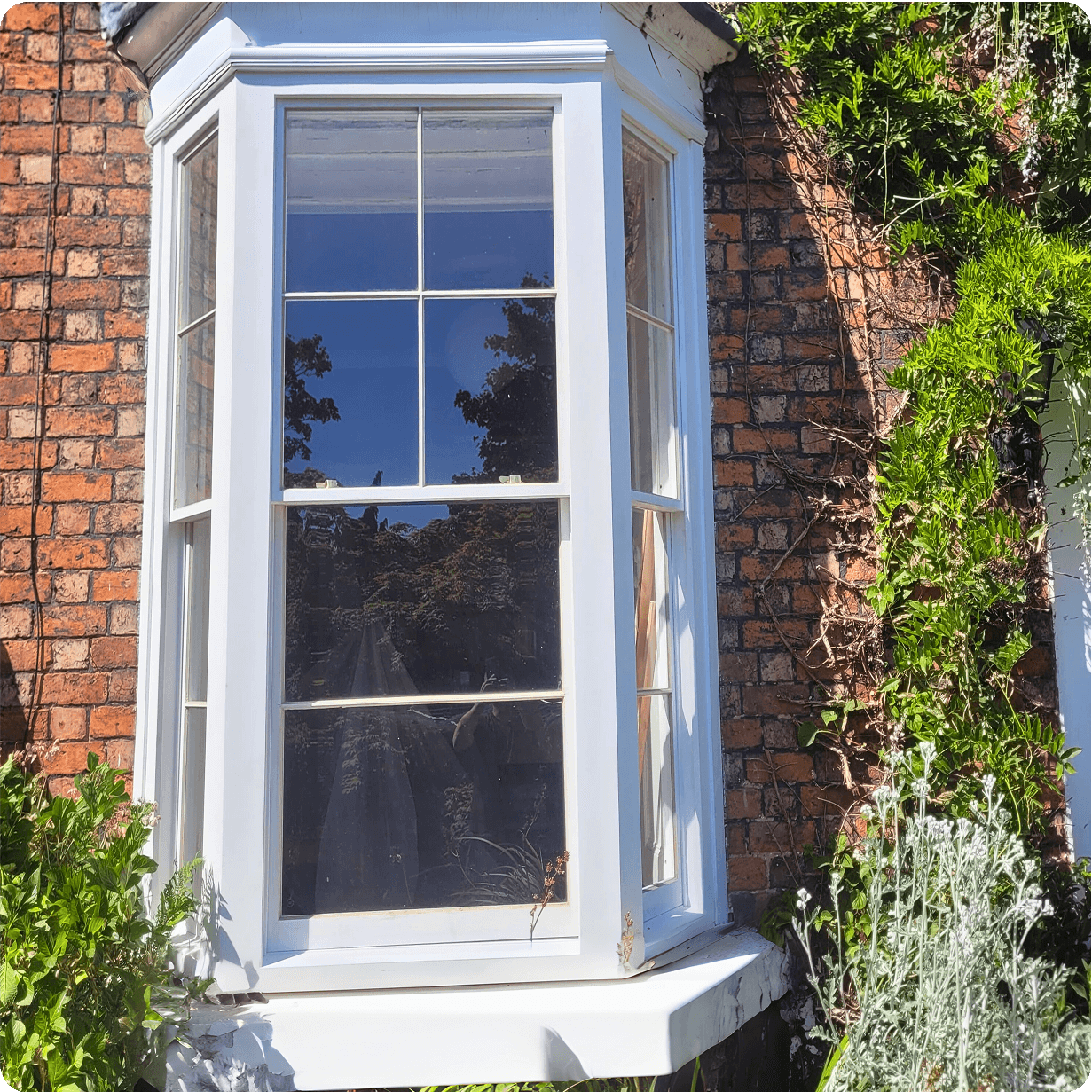 Image of a bespoke timber windows fitted onto the bay window of a house by Preferred Joinery.
