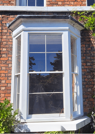 Image of a bespoke timber windows fitted onto the bay window of a house by Preferred Joinery.