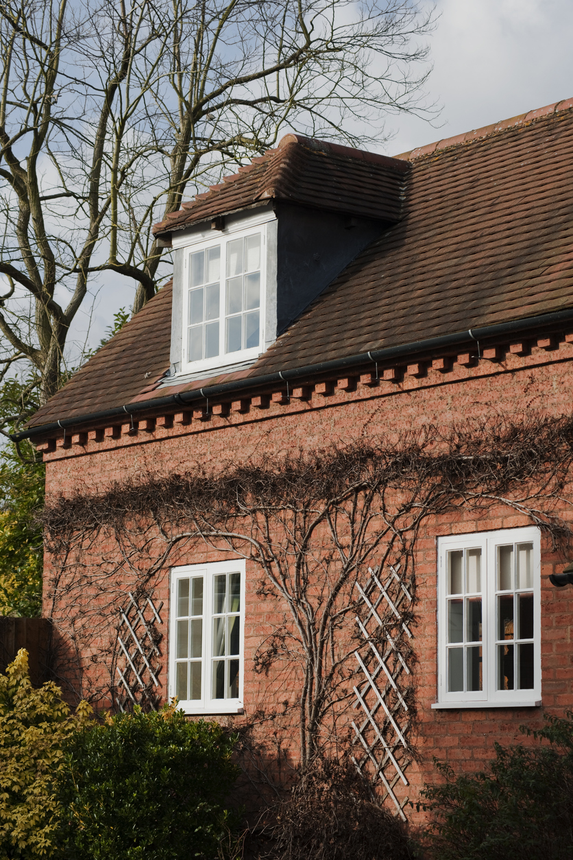 Timber casement windows on a red brick town house
