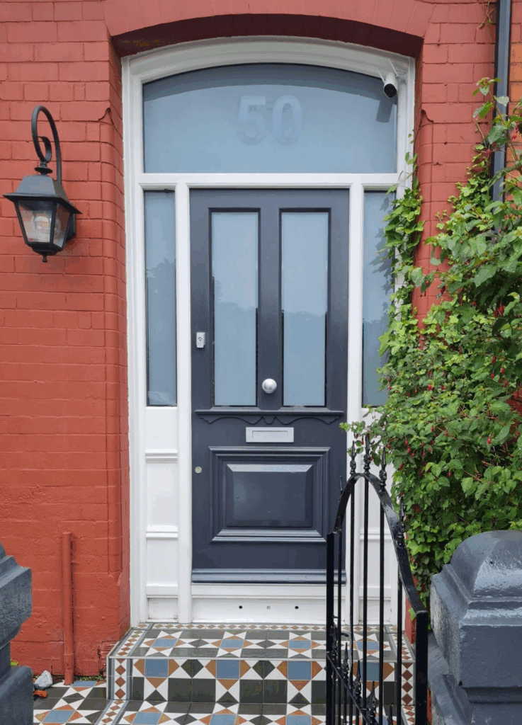 black and white  hardwood Edwardian-style front door with  with the number 50 on